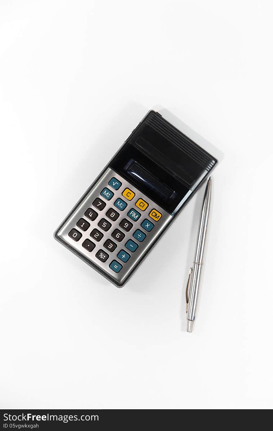 Old calculator and pen on white background