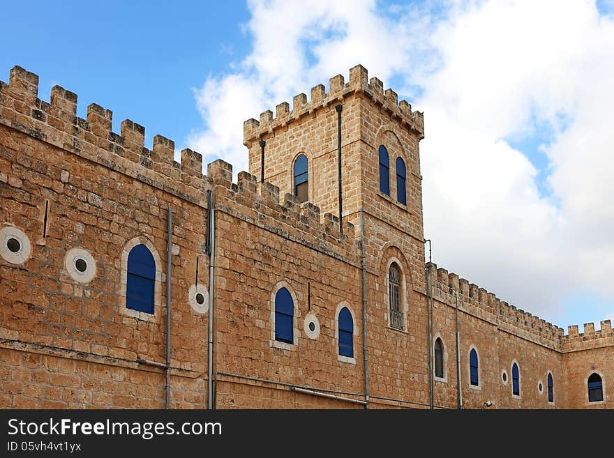 Monastery wall on the cloudy sky background. Beit Jemal women's Catholic monastery. Israel