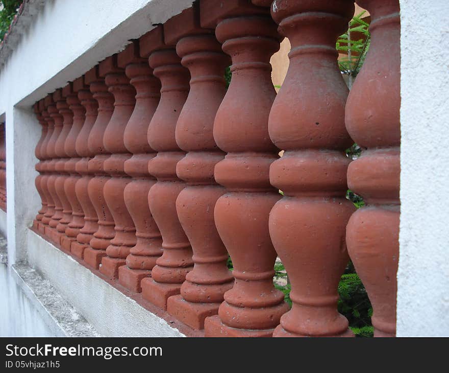 Villa fence of brick-red ceramic with white concrete frame. Villa fence of brick-red ceramic with white concrete frame