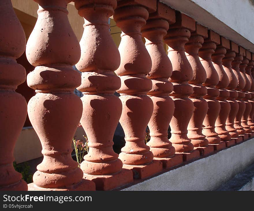 Villa fence of brick-red ceramic with white concrete frame. Villa fence of brick-red ceramic with white concrete frame