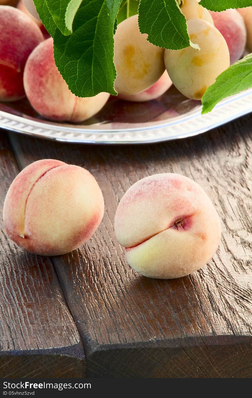 Ripe goldish velvety peaches and yellow plums