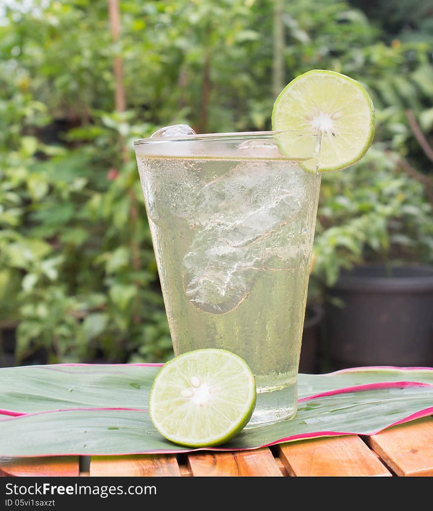 Cold lemonade in a glass with ice cubes