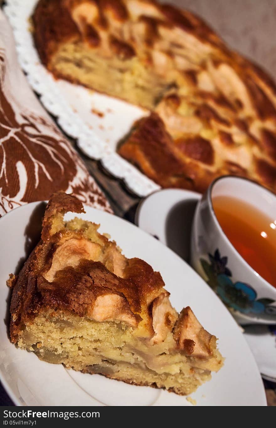 Homemade apple pie surrounded by fresh apples