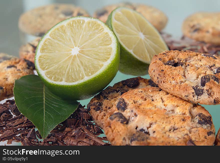 Cookies with chocolate and lemon on a green background. Cookies with chocolate and lemon on a green background