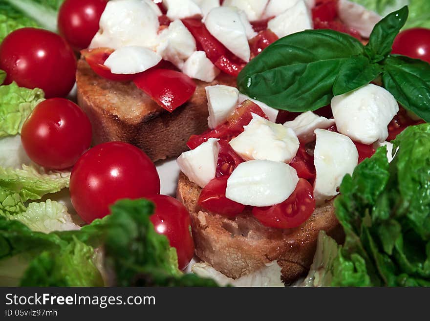 Close up of mozzarella tricolore salad with tomatoes and basil with drizzling. Close up of mozzarella tricolore salad with tomatoes and basil with drizzling