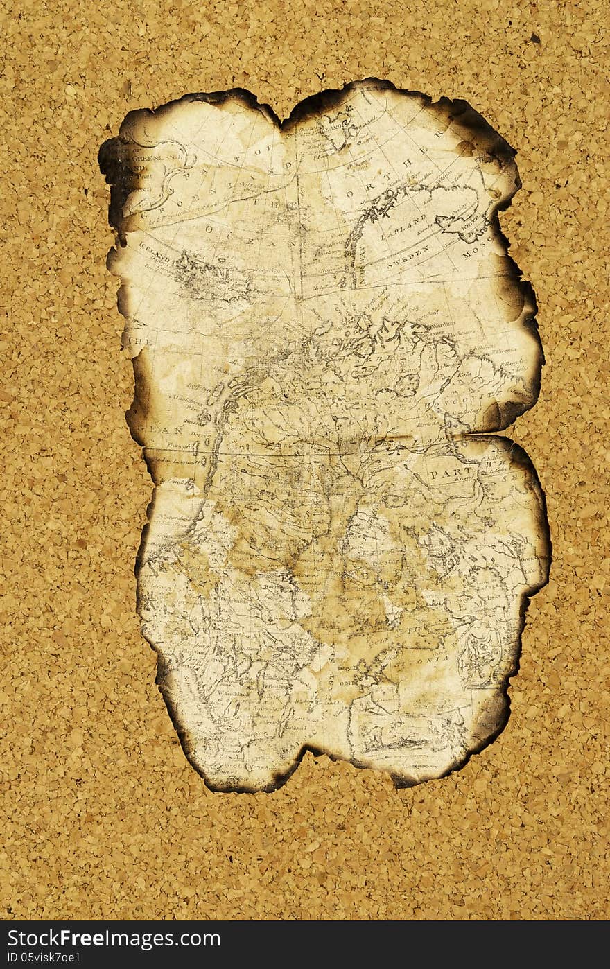 Old map with burnt edges lies on the surface of the cork