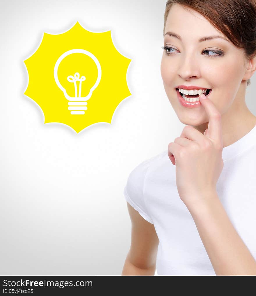 Portrait of beautiful smiling white woman with electric lamp idea concept