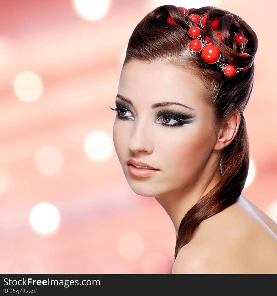 Beautiful woman with creative hairstyle and fashion makeup