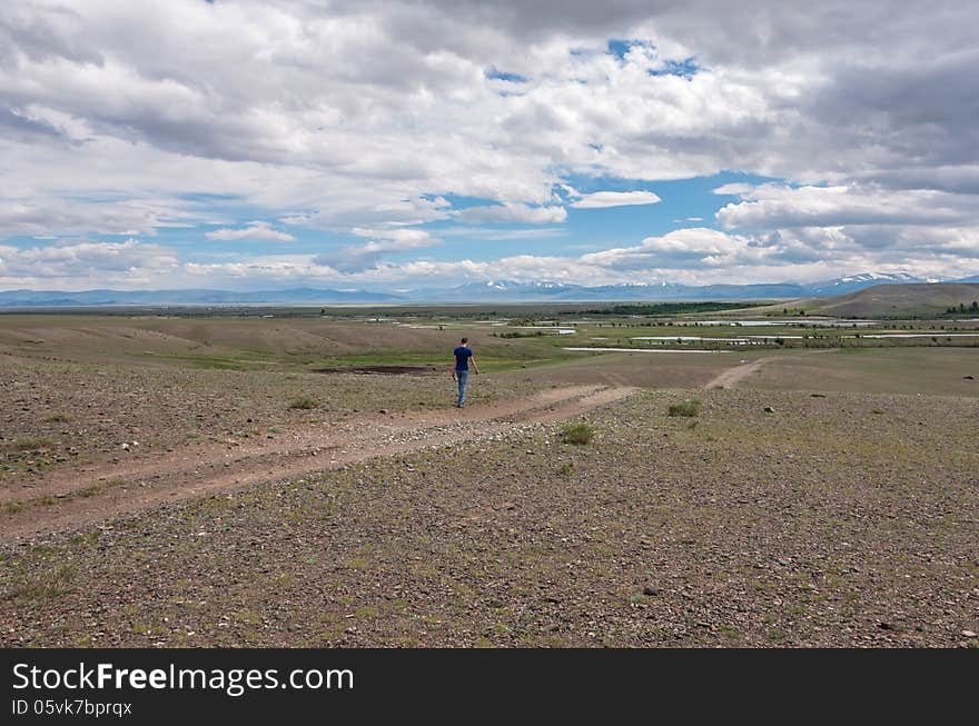 Man Goes Along Dirt Road Steppe Sky