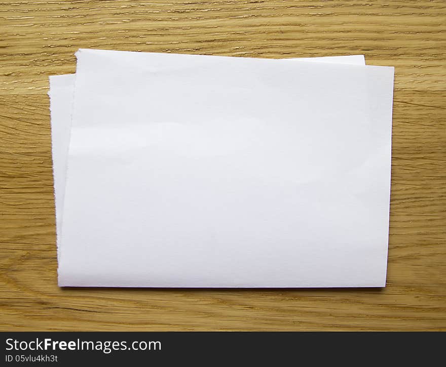 Sheet of blank paper isolated on wooden background