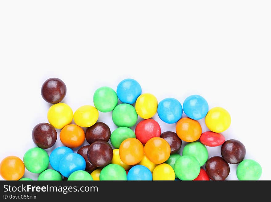 Chocolate balls in colorful glaze are bottom background. Chocolate balls in colorful glaze are bottom background.