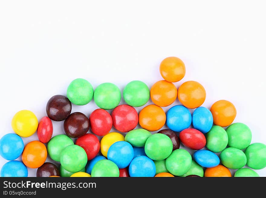 Chocolate balls in colorful glaze are bottom.