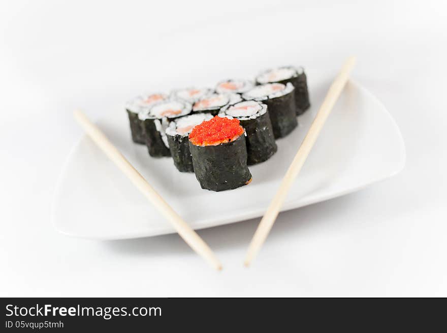 Sushi menu and chopsticks on plate, white background, traditional food in Japan and Asia. Sushi menu and chopsticks on plate, white background, traditional food in Japan and Asia