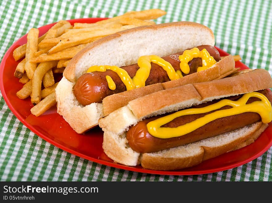 hotdogs with mustard and fries