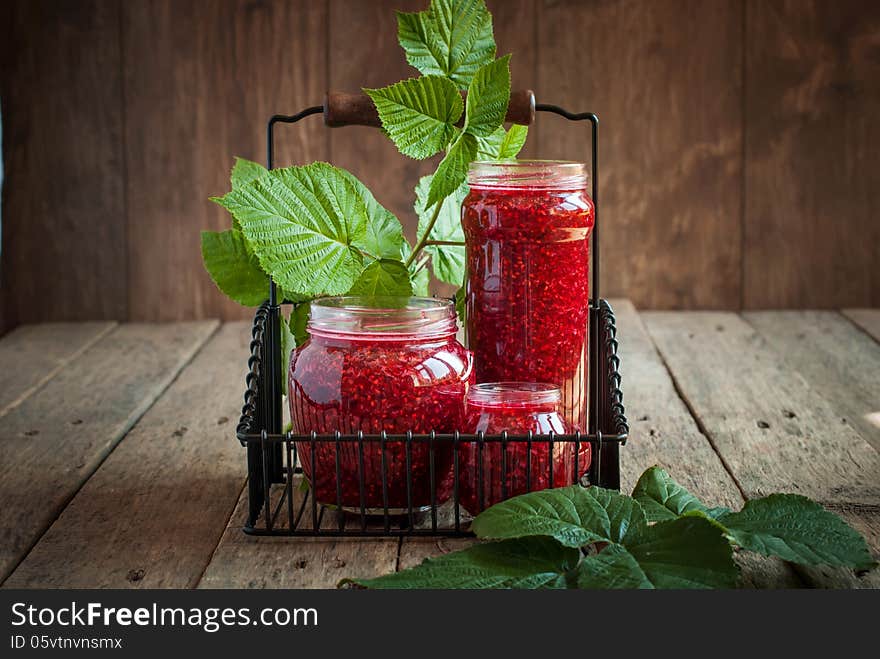 Raspberry Leaves and Jam in a jars on the wooden table