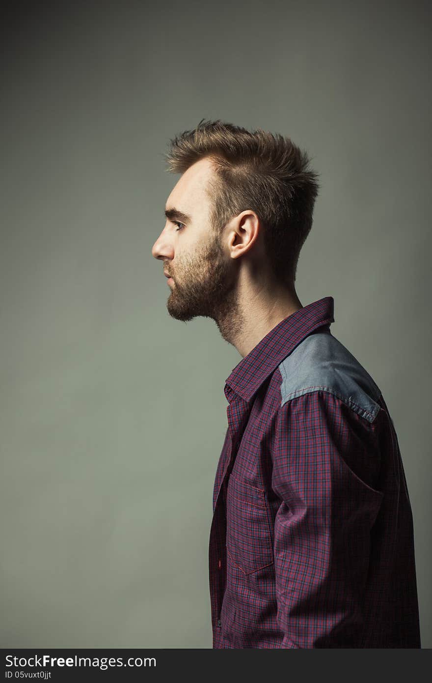 A young adult man on a dark background