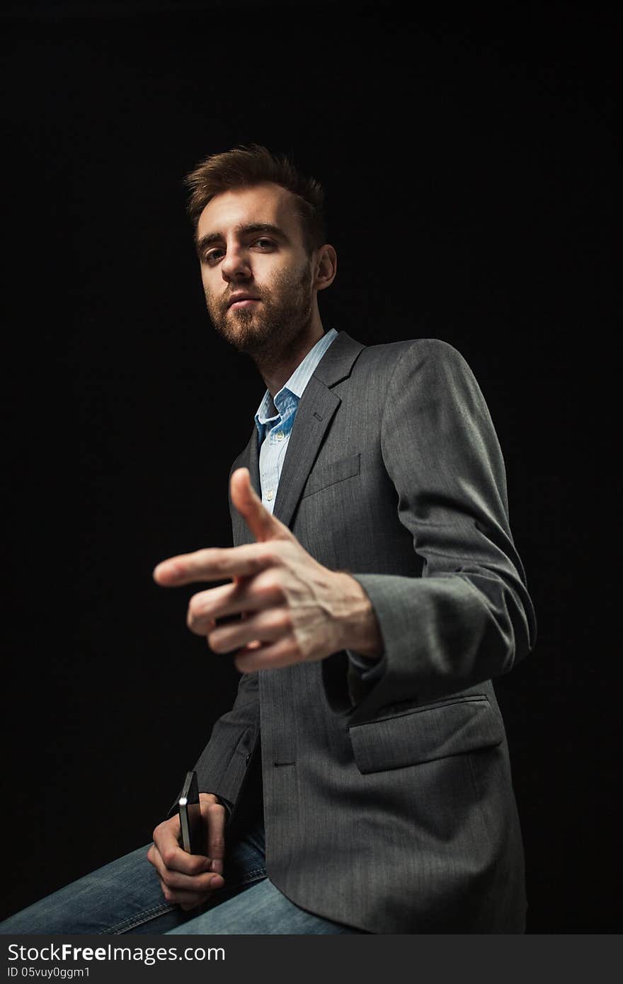 Young Businessman On A Dark Background