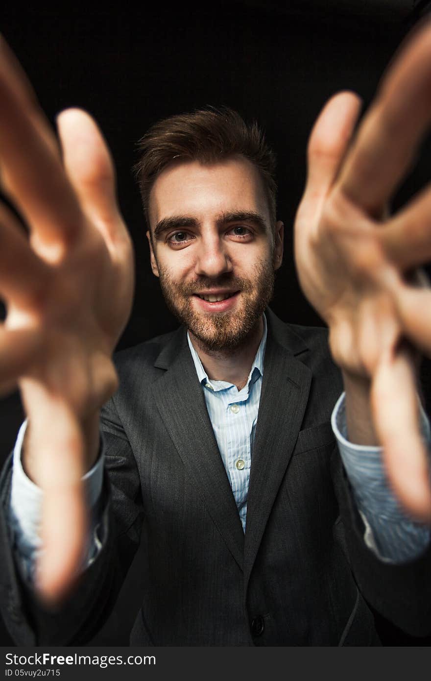 Young businessman on a dark background