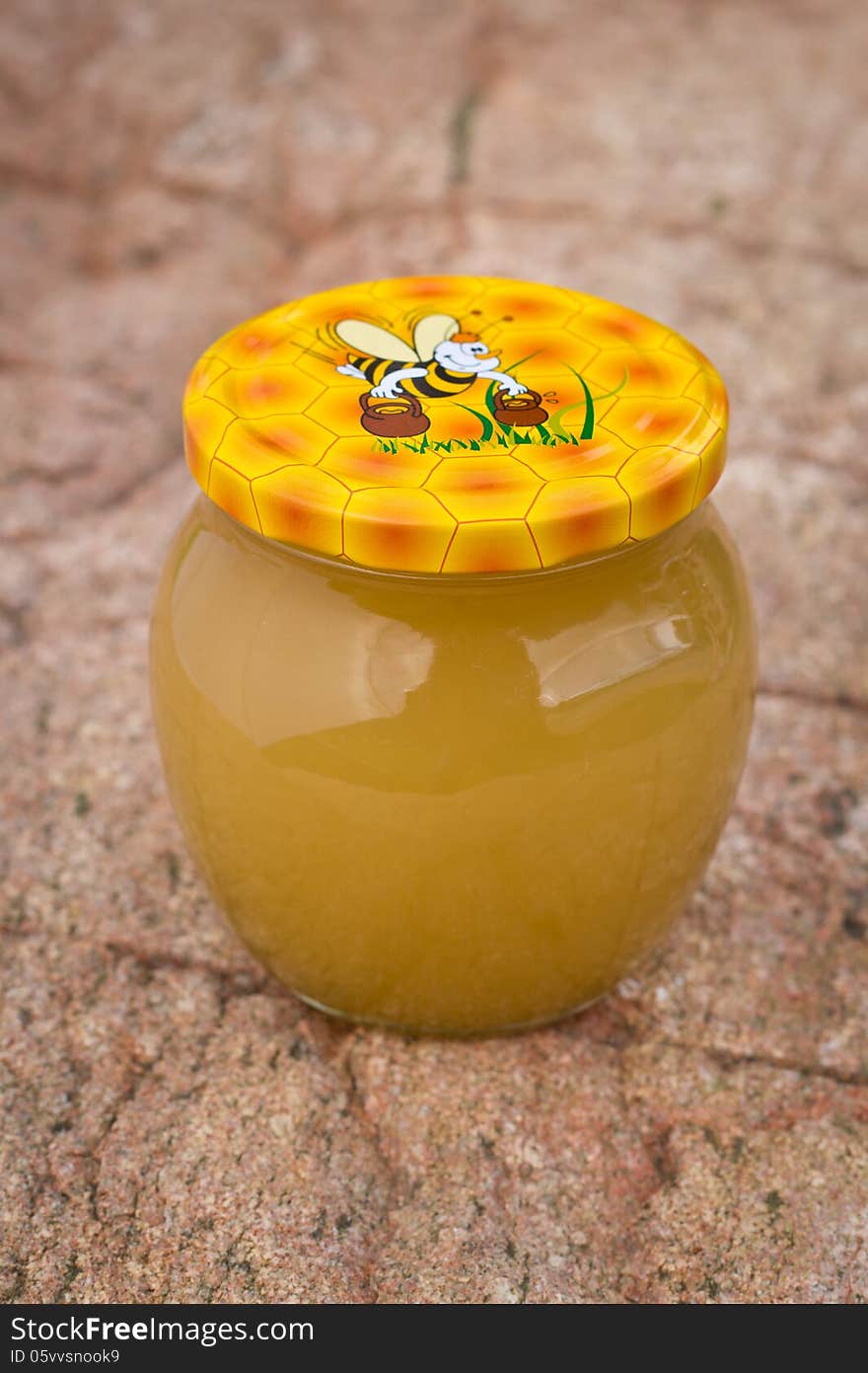 Nice gift jar of honey on stone background