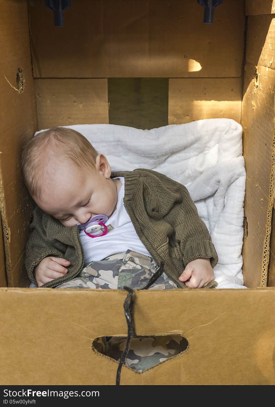 Small Baby sleeping in cardboard box. Small Baby sleeping in cardboard box.