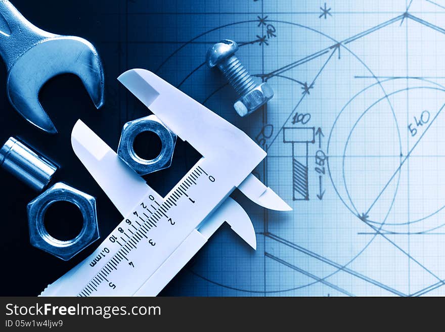 Closeup of work tools and ruler on graph paper with draft