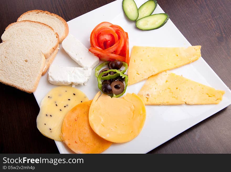 Cheese and olive, tomato platter with vegetable and herbs. Cheese and olive, tomato platter with vegetable and herbs