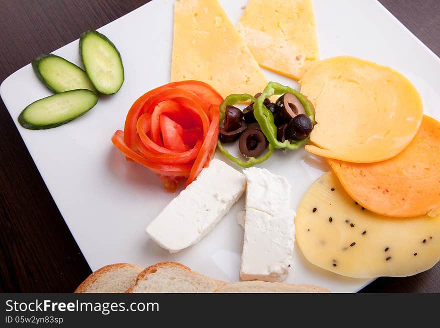 Cheese and olive, tomato platter with vegetable and herbs. Cheese and olive, tomato platter with vegetable and herbs