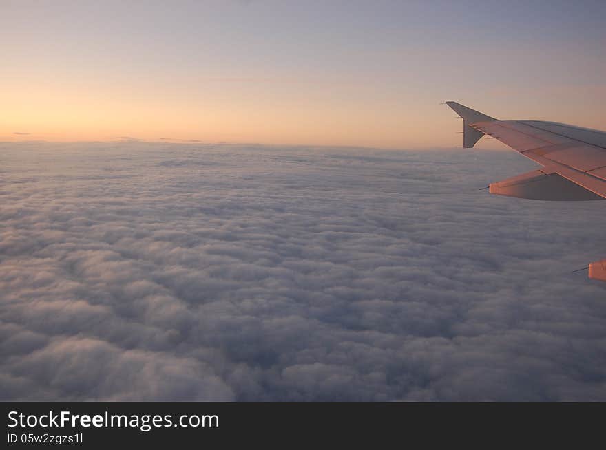 Wing and Clouds like cotton in the sky at the sinrise or sunset. Wing and Clouds like cotton in the sky at the sinrise or sunset