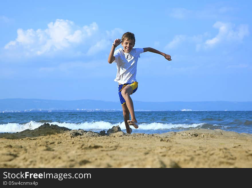 Boy running along beach