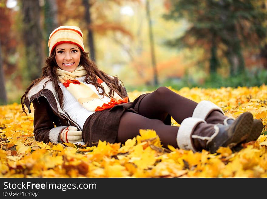 Smiling girl lying autumn park on leaves. Smiling girl lying autumn park on leaves