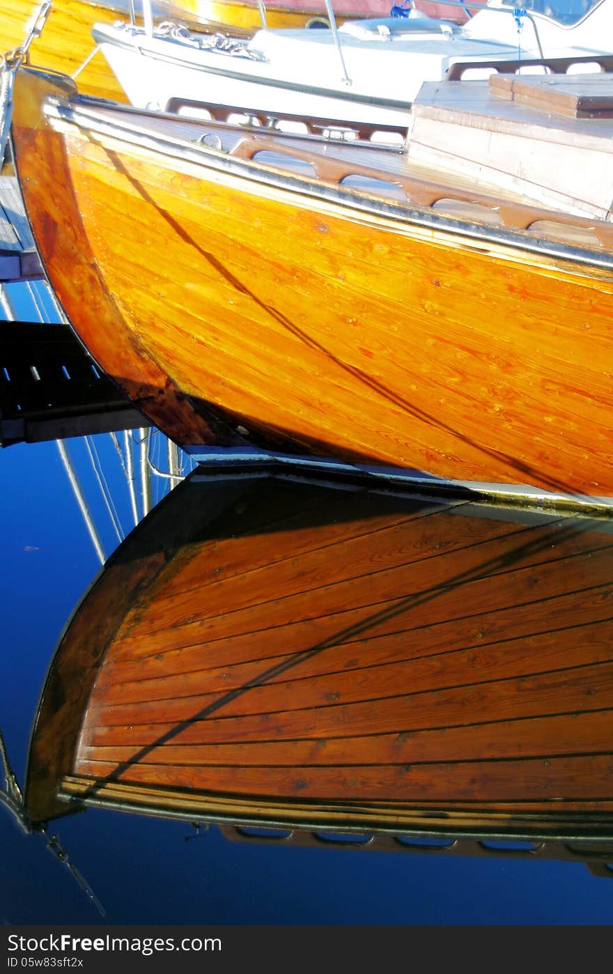 Beautiful reflection of a wooden boat on the water