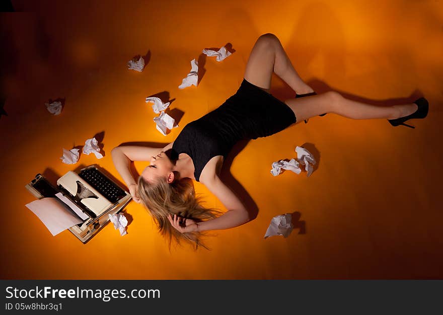 Girl lying beside the typewriter