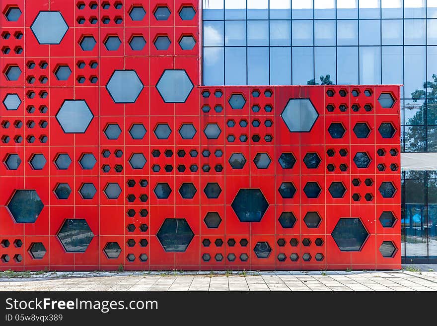 Modern red outer wall with geometry shape windows. Modern red outer wall with geometry shape windows