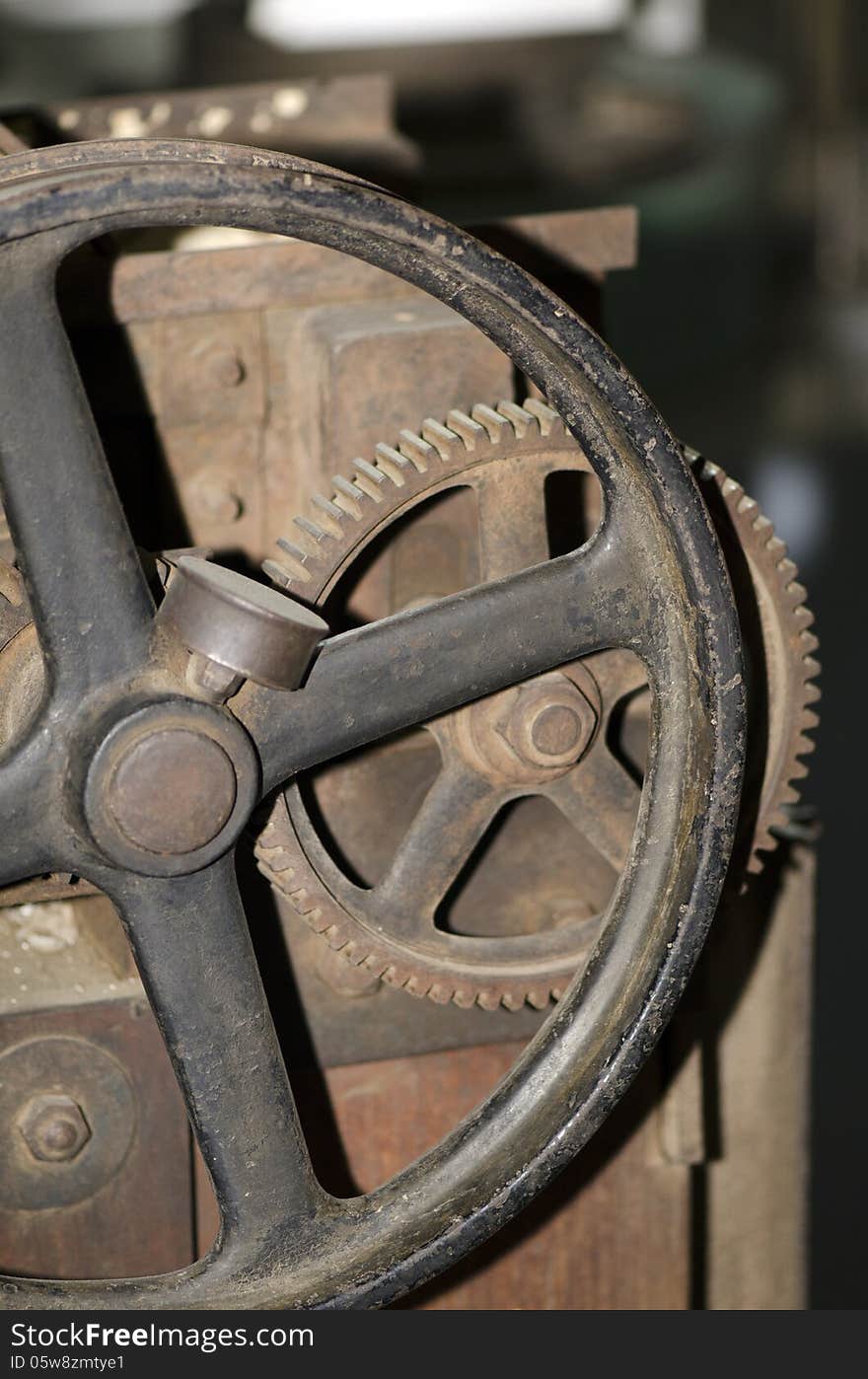 An rusted iron gear of an antiquated steam machine. An rusted iron gear of an antiquated steam machine