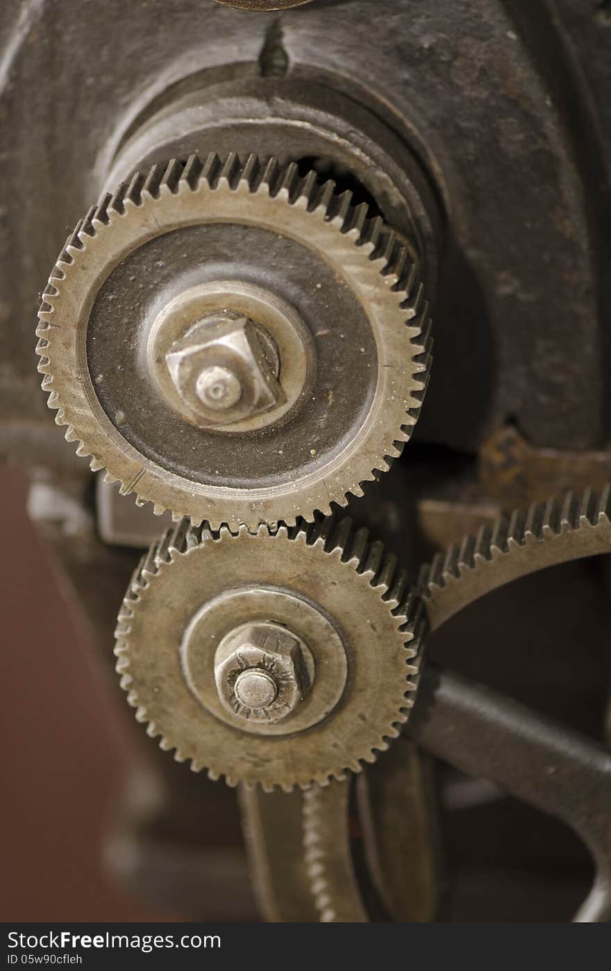 An rusted iron gear of an antiquated steam machine. An rusted iron gear of an antiquated steam machine