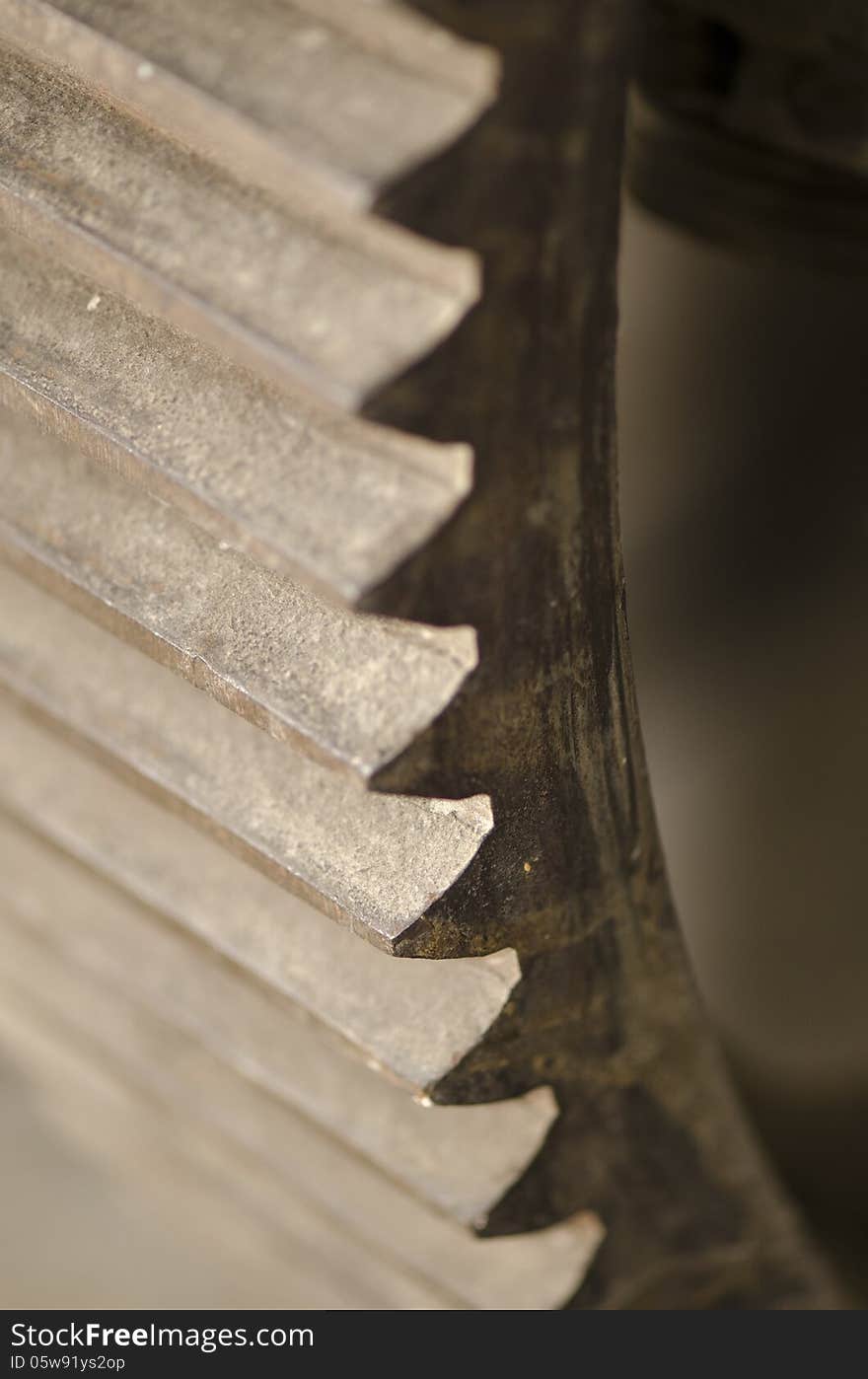 An rusted iron gear of an antiquated steam machine. An rusted iron gear of an antiquated steam machine