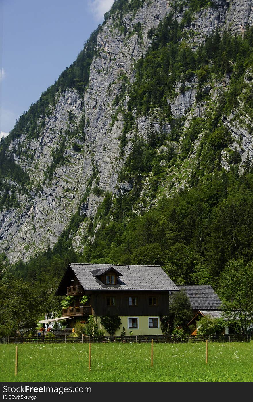 House under the alps cliff