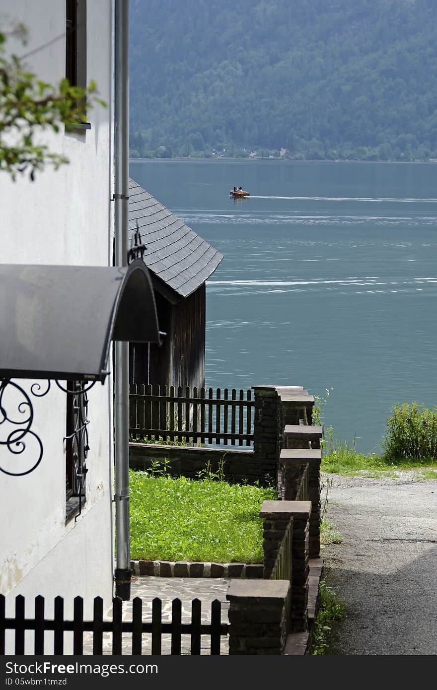 Alleyway to the lake in hastadtt with House on the edge of the lake Austria