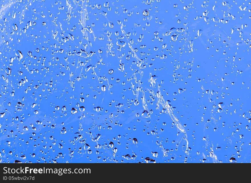 Wet film coated with water drops. background