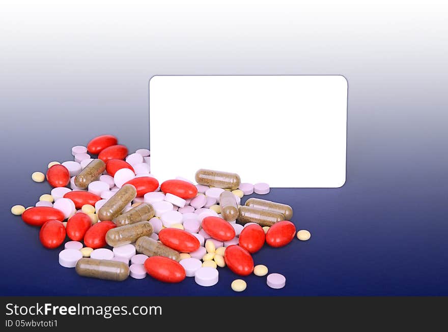 A lot of colorful pills. space for text. blue gradient background. A lot of colorful pills. space for text. blue gradient background.