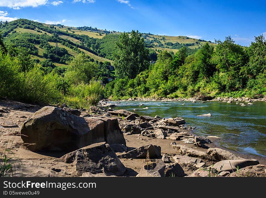 Stone river beach near the mountain village