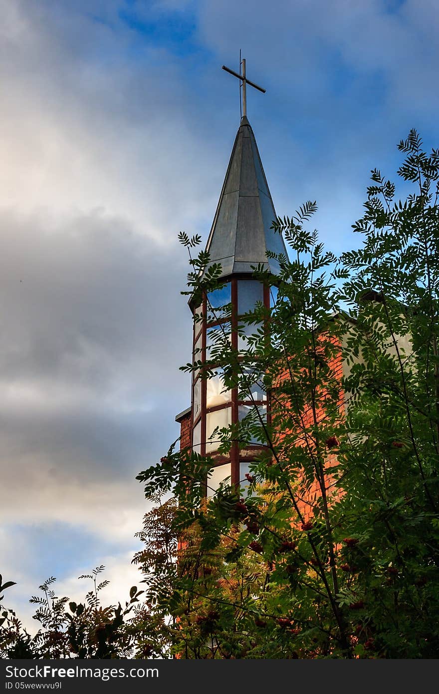 Dome of the church is hidden behind branches of viburnum. Dome of the church is hidden behind branches of viburnum