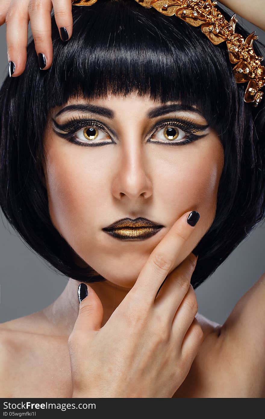 Close-up portrait of a beautiful girl with an evening make-up and jewelery