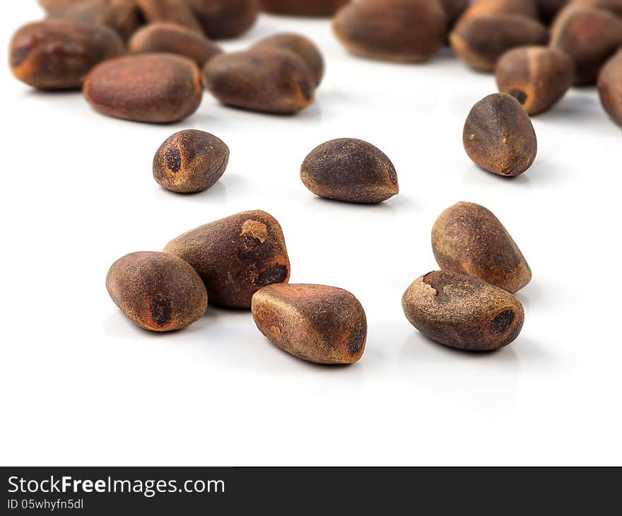 Cedar (Cedrus sp.) nuts on a white background. Cedar (Cedrus sp.) nuts on a white background.