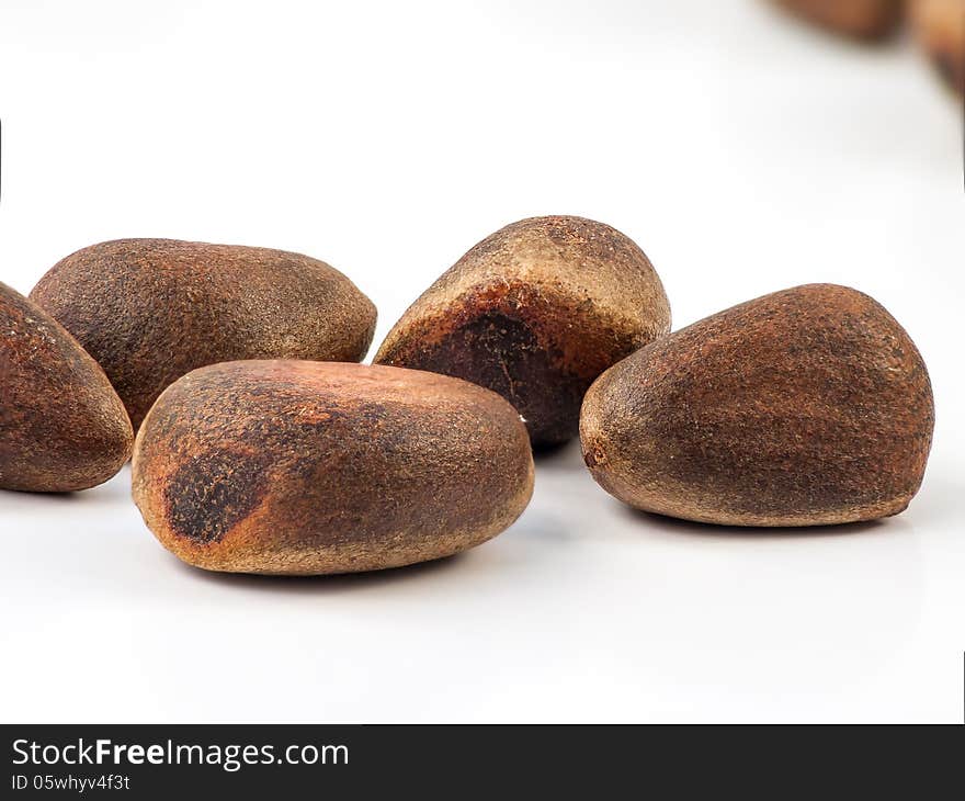 Cedar (Cedrus sp.) nuts on a white background. Cedar (Cedrus sp.) nuts on a white background.