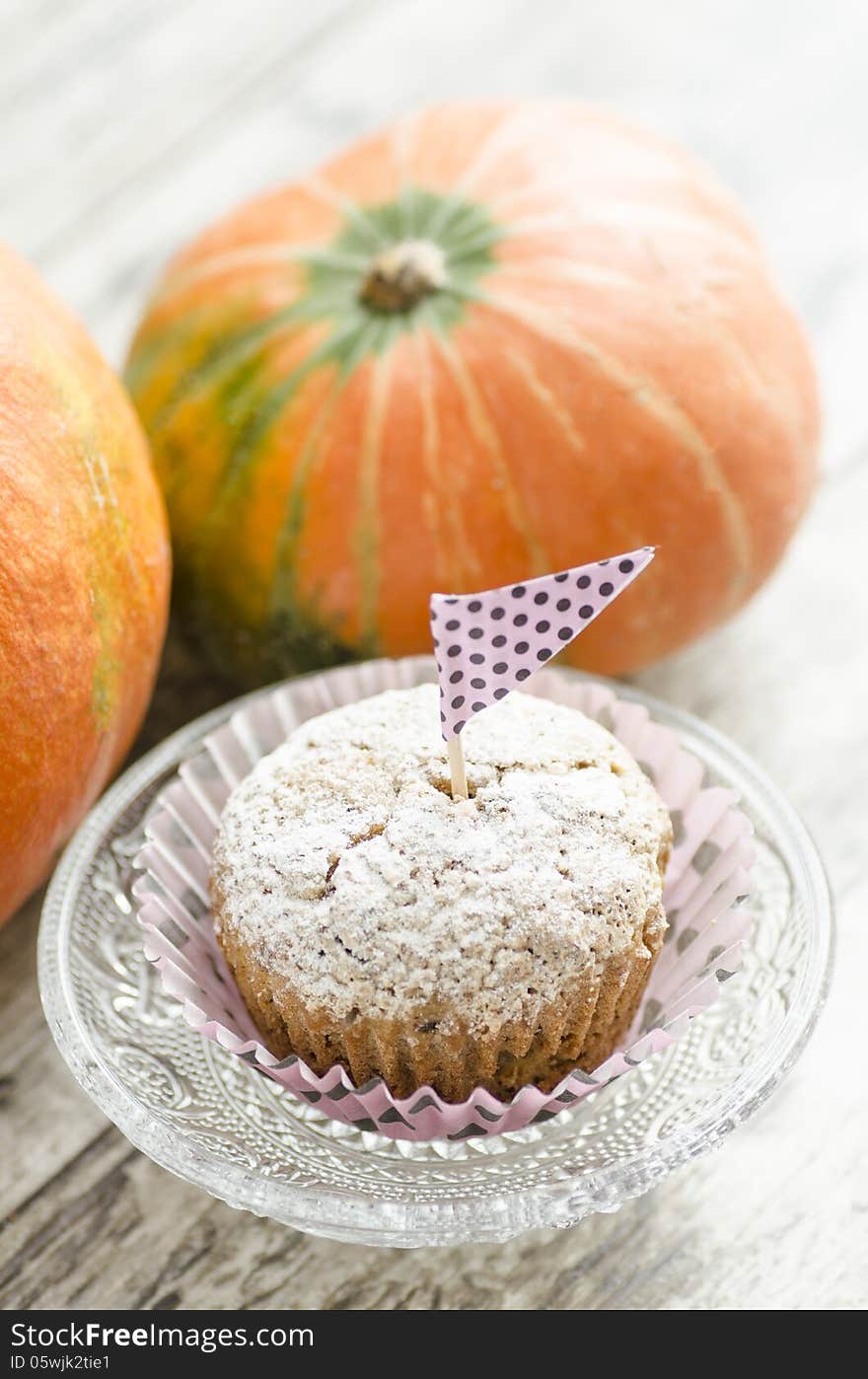 Cupcake On Glass Plate. Pumpkin Background