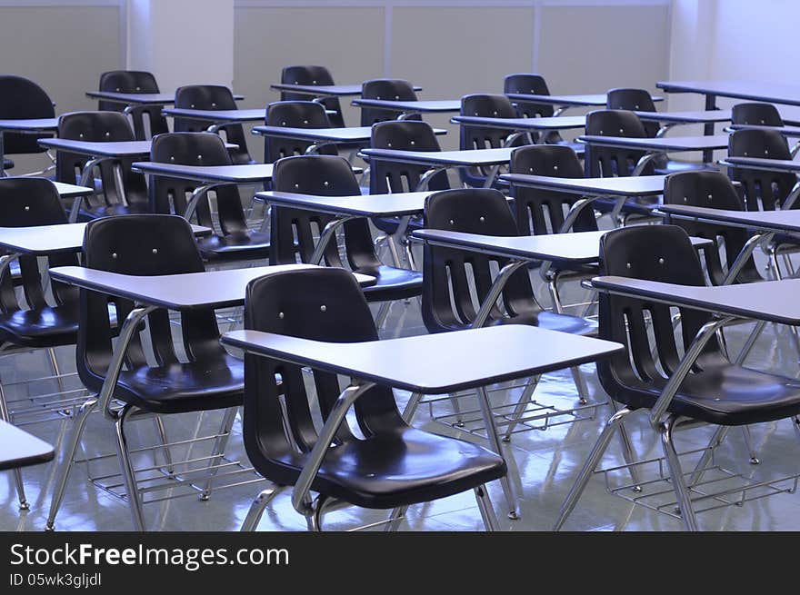 Clean classroom with black tabchairs, shiny floor and white boards ready for back to school. Clean classroom with black tabchairs, shiny floor and white boards ready for back to school