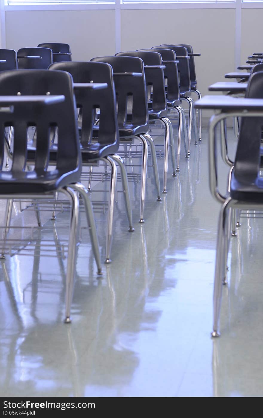 Clean classroom with black tab-chairs, shiny floor ready for back to school. Clean classroom with black tab-chairs, shiny floor ready for back to school