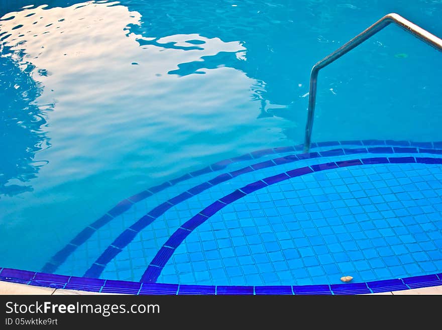 Luxury Resort Swimming Pool high angle on curved edge of a luxury resort swimming pool. Luxury Resort Swimming Pool high angle on curved edge of a luxury resort swimming pool