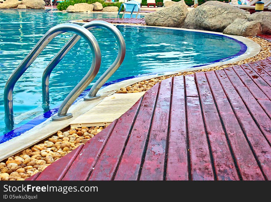 Luxury Resort Swimming Pool high angle on curved edge of a luxury resort swimming pool. Luxury Resort Swimming Pool high angle on curved edge of a luxury resort swimming pool